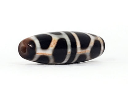 V-092824-DLBS2 Double Longevity dzi bead, angled end view, warm brown drill tip and pitch-black body, unretouched