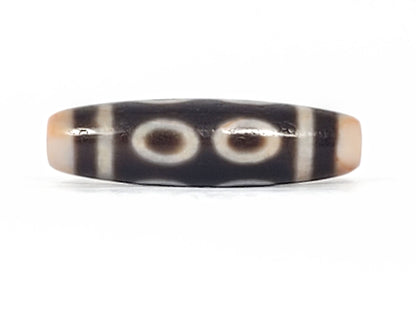 V-092924-8EBS Eight Eye dzi bead, rotated face showing four eyes, minor equatorial surface marks visible, unretouched