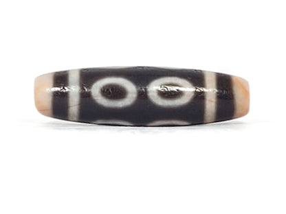 V-092924-8EBS Eight Eye dzi bead, fourth face angle, cream eye rings on deep dark brown ground, unretouched