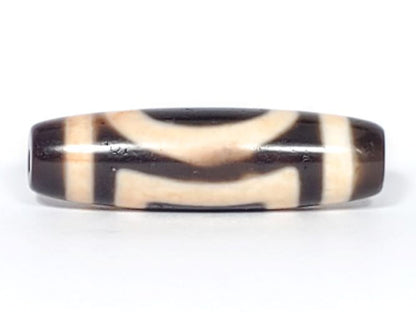 V-082123-HEBS Heaven & Earth dzi bead, opposite angled end view, chestnut-brown cap, dark brown body, Heaven circle face, unretouched