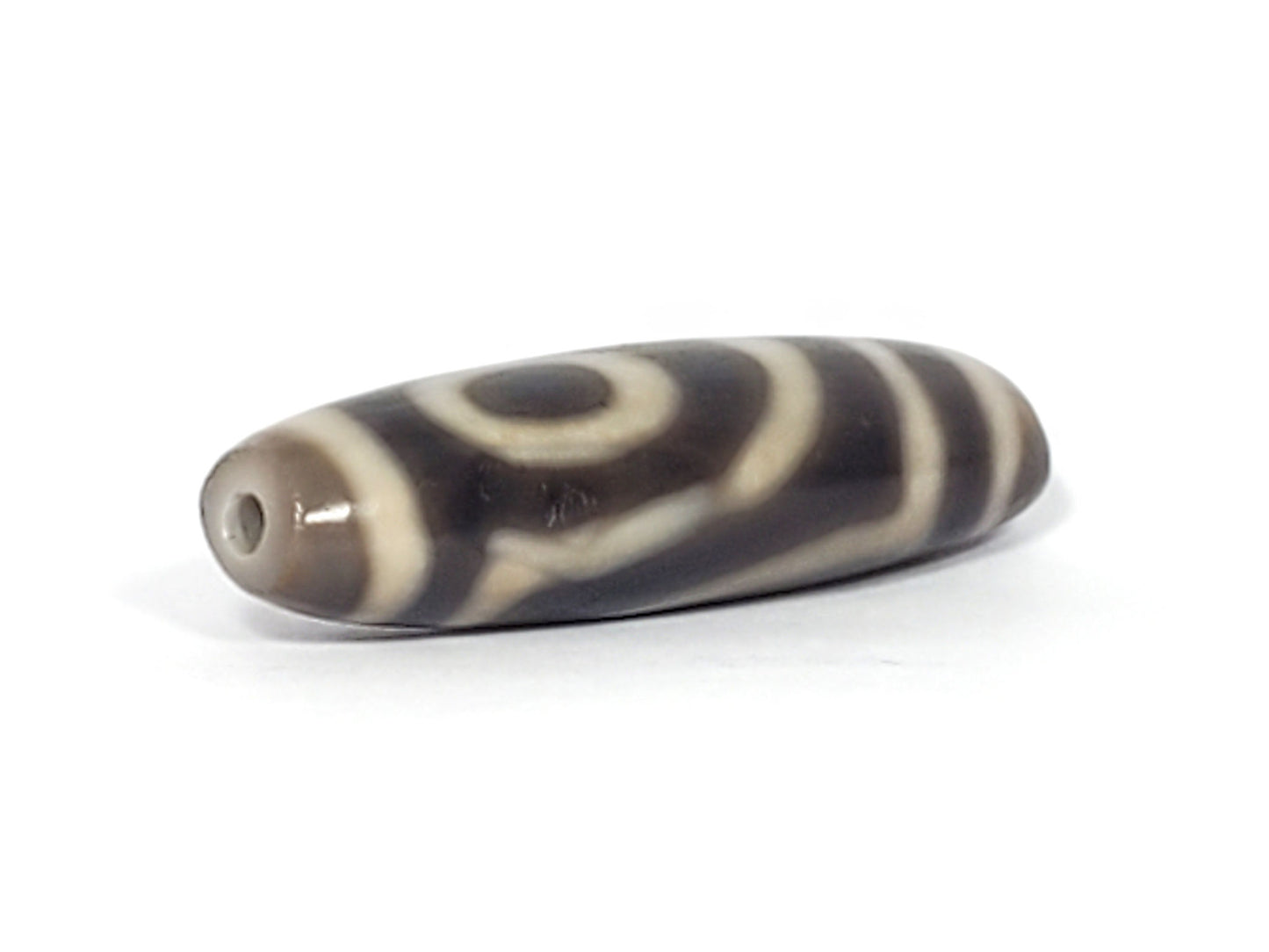 Ac-071026-TWE3 ancient two eye dzi angled view drill end B charcoal grey-brown end cap unretouched