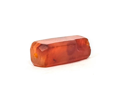Ac-071026-CBEV2 ancient beveled carnelian angled view significantly chipped drill end intact hole unretouched