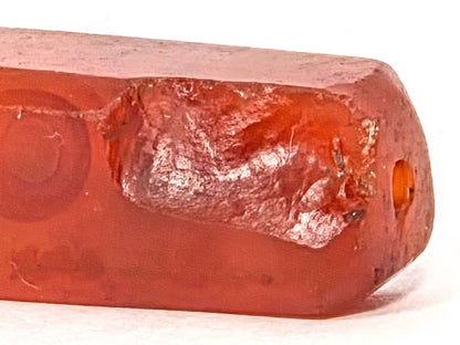 Ac-071026-CBEV2 ancient beveled carnelian macro significantly chipped end ancient fracture patinated intact hole unretouched