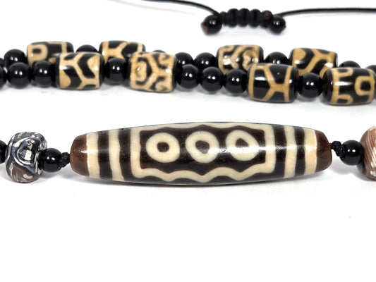 Ancient 7-eye dzi bead necklace, dark brown agate, cream eye motifs, wave pattern, aged patina, black onyx spacers