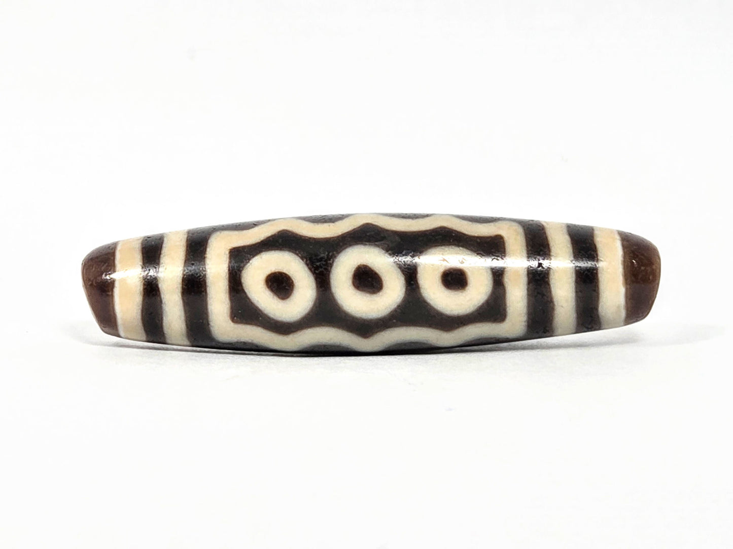 Ac-071026-7E ancient seven eye dzi 54.6x13.3mm dark brown agate three-eye face wavy border unretouched