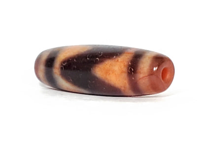 Ac-071026-TaBS ancient tasso dzi angled view drill end A bright orange-red end cap small clean hole unretouched