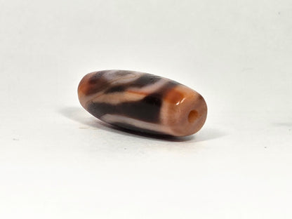 Ac-090326-2E ancient two eye dzi reddish-brown agate angled drill end terracotta cap close view, unretouched