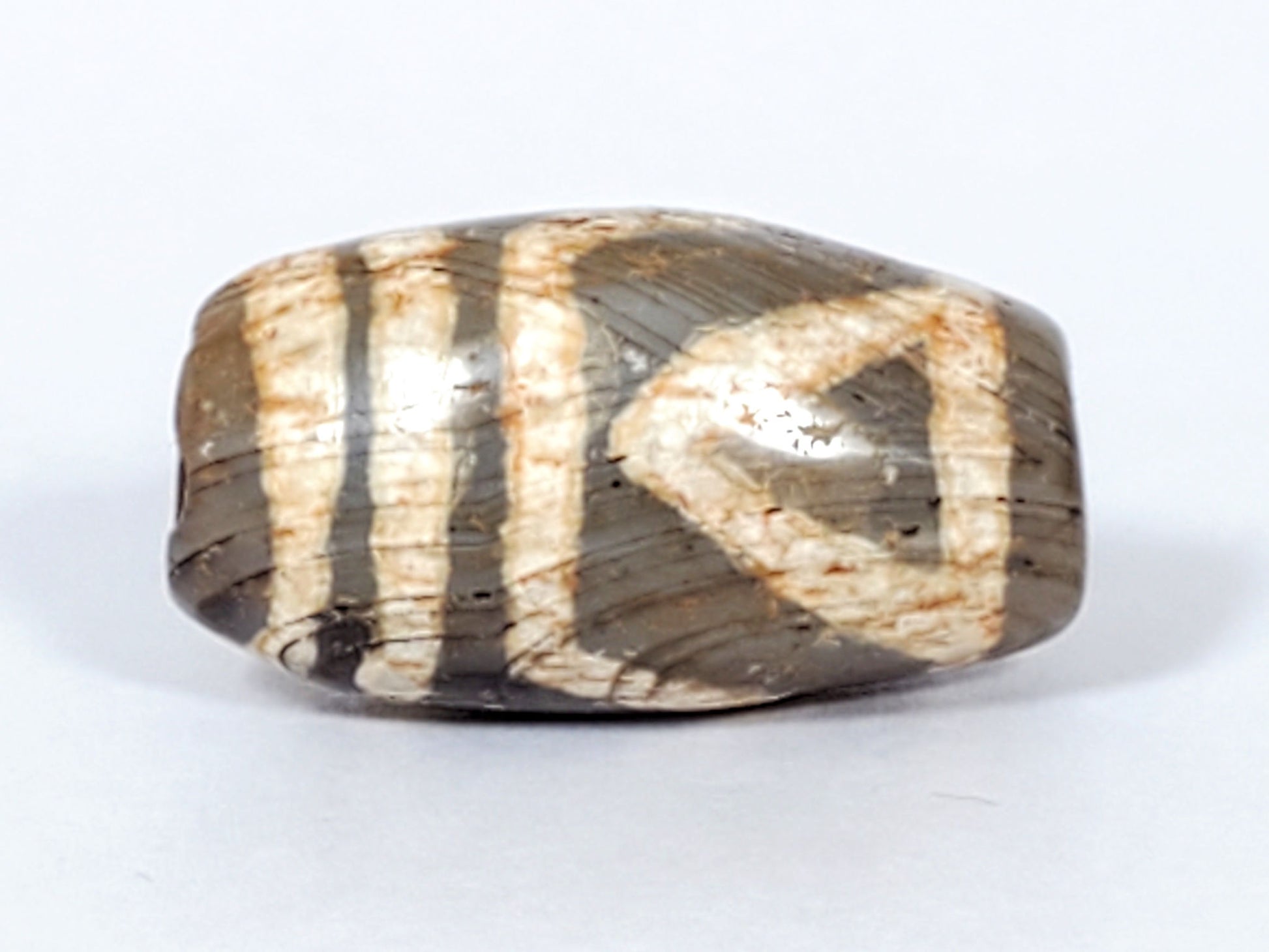 Second view of ancient Two Eye Dzi — natural agate banding and cream eye pattern visible