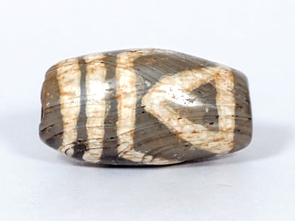 Second view of ancient Two Eye Dzi — natural agate banding and cream eye pattern visible