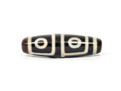Antique Tibetan dzi bead, four-eye motif, dark brown agate with white oval rings, weathered patina, elongated barrel shape