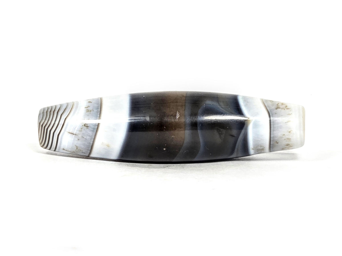 At-N-071426-NBA natural banded agate face C — asymmetric taper visible, pitch-black body, white-grey bands, unretouched.