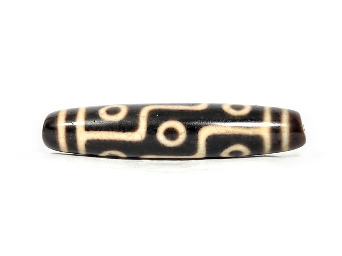 At-070826-9E antique nine eye dzi bead very dark brown agate third face showing cream craquelure zones unretouched