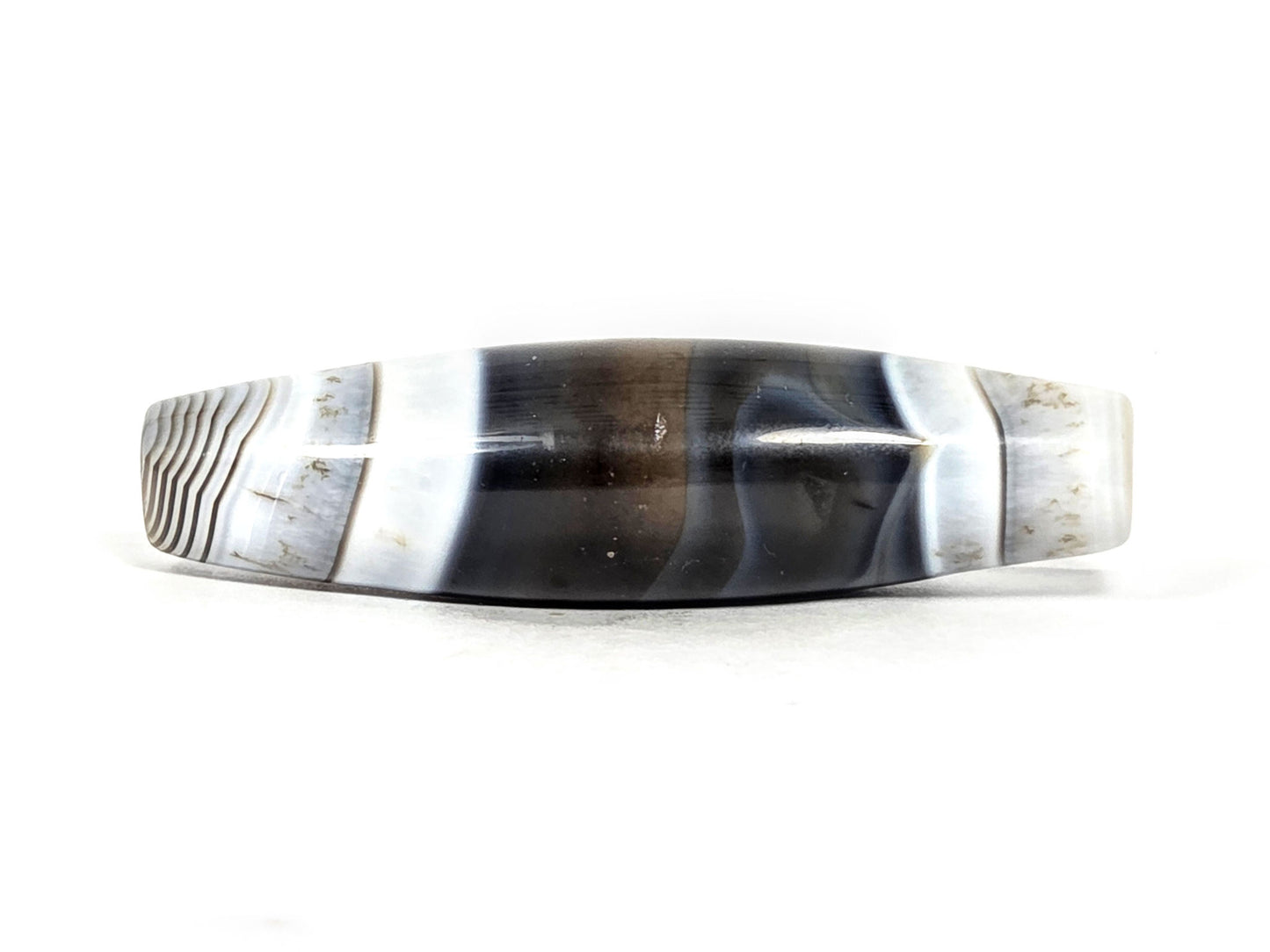 At-N-071426-NBA natural banded agate face C — asymmetric taper visible, pitch-black body, white-grey bands, unretouched.