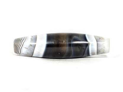 At-N-071426-NBA natural banded agate face C — asymmetric taper visible, pitch-black body, white-grey bands, unretouched.