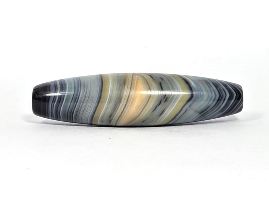At-N-080426-1E2 antique natural one eye dzi bead 59.3×15.2mm, Face A showing resolved warm gold eye in blue-grey banded agate, unretouched