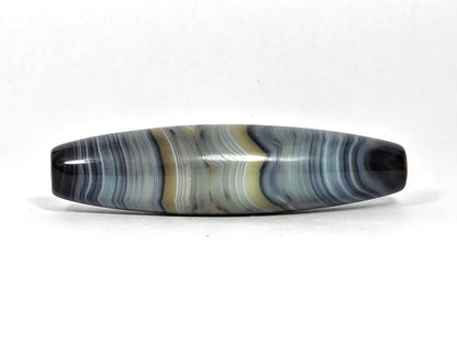 At-N-080426-1E2 antique natural one eye dzi bead 59.3×15.2mm, turn view showing cream and white bands prominent with warm zone receding, unretouched