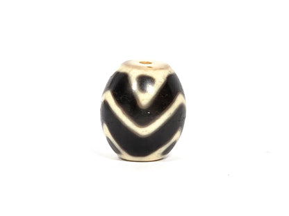 At-080926-WTT antique round Wave Tiger Tooth dzi bead 17.8×15.6mm, rotation C showing tiger tooth upper zone, broader arc chevrons, and age surface texture in cream zones, unretouched