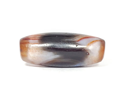 Side view of antique Tasso dzi bead showing black center zone and warm reddish-brown banding, At-052526-TaBS