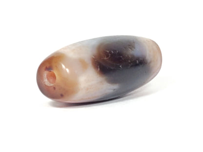 End view of antique Tasso dzi bead showing drill hole, grey-black and reddish-brown natural agate, At-052526-TaBS