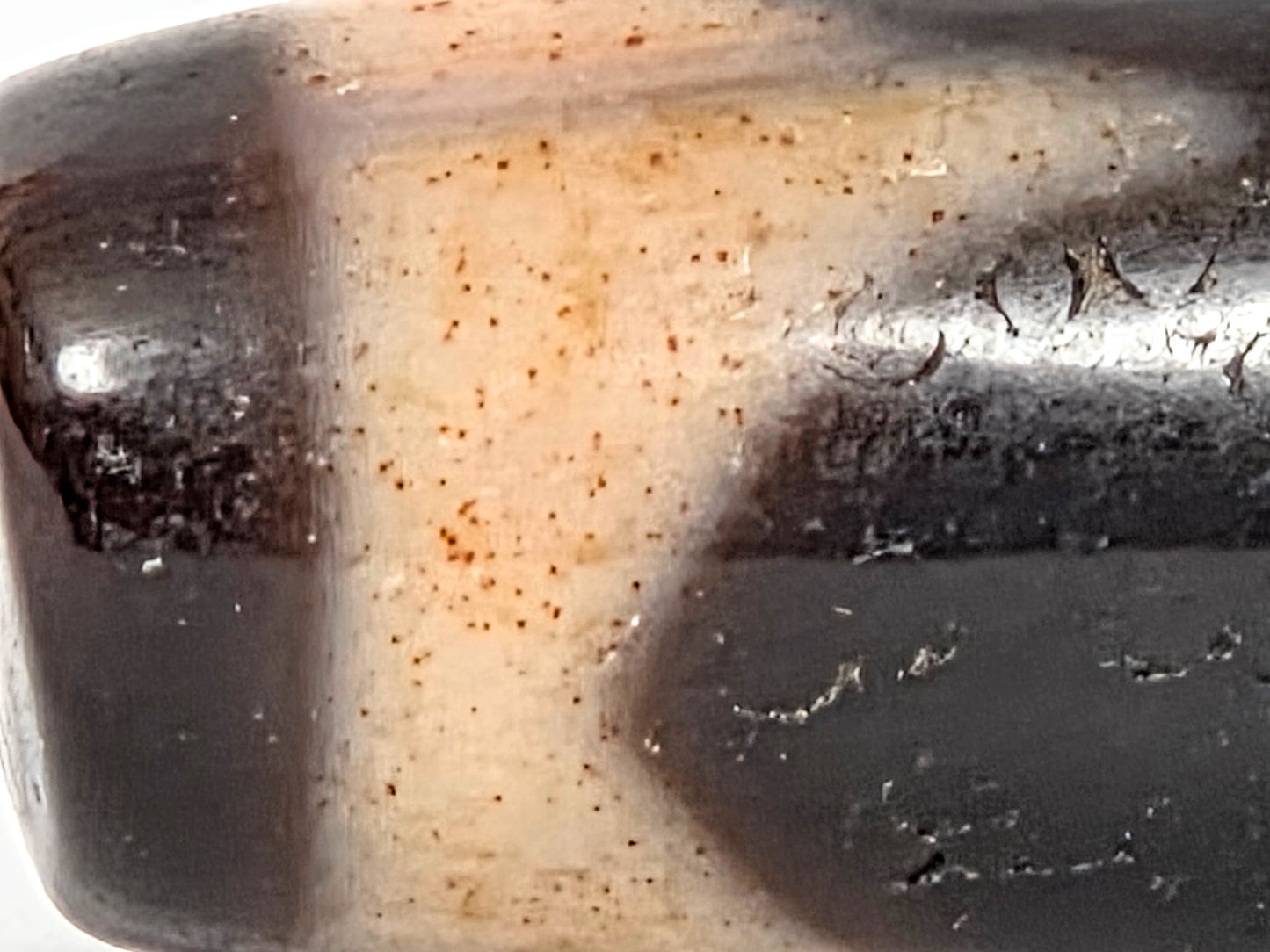 At-071426-TaBS4 macro 2 — scattered reddish-orange cinnabar pinpoint dots across cream zone, Tier 3 bloodspots, unretouched. 