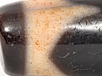 At-071426-TaBS4 macro 2 — scattered reddish-orange cinnabar pinpoint dots across cream zone, Tier 3 bloodspots, unretouched. 