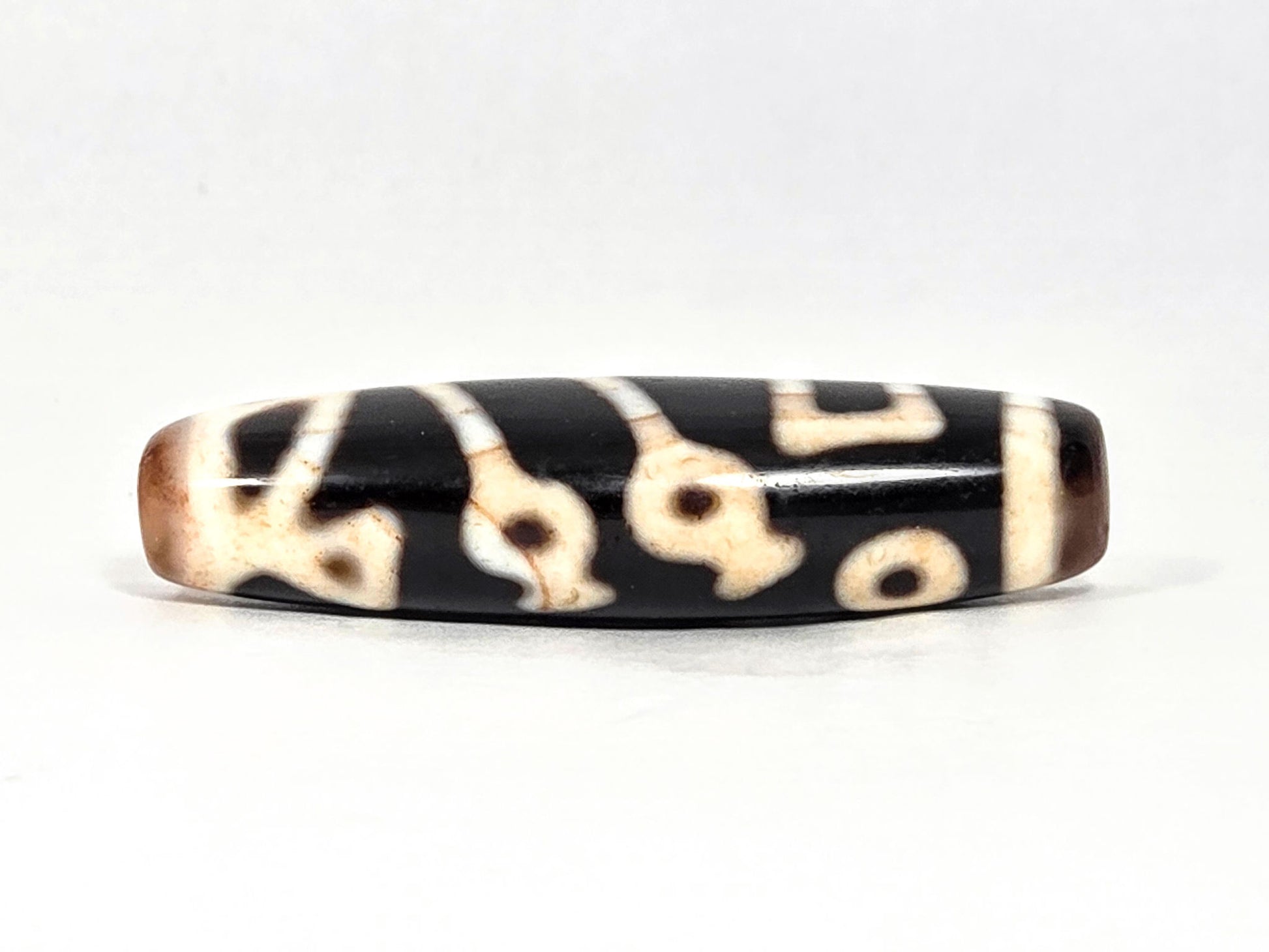 At-070726-TOLBS antique Tree of Life dzi pitch-black agate rotated face showing organic loop forms cream motif unretouched