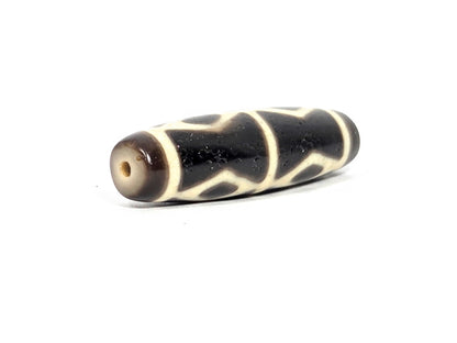 At-072226-6EDS end angle B — opposite warm end cap, pitch-black body, cream diamond elements visible, unretouched. 