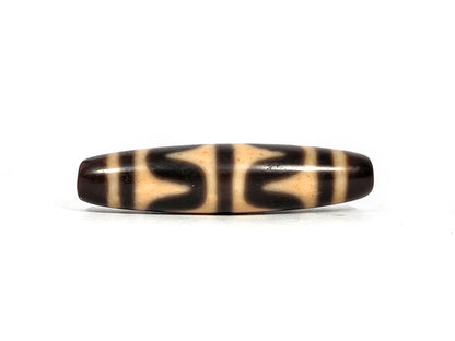 Second lateral profile of antique Tibetan double wave dzi bead showing reverse face with dark brown wave motif panels and vertical stripe separators on warm honey-tan agate, 49.7 mm