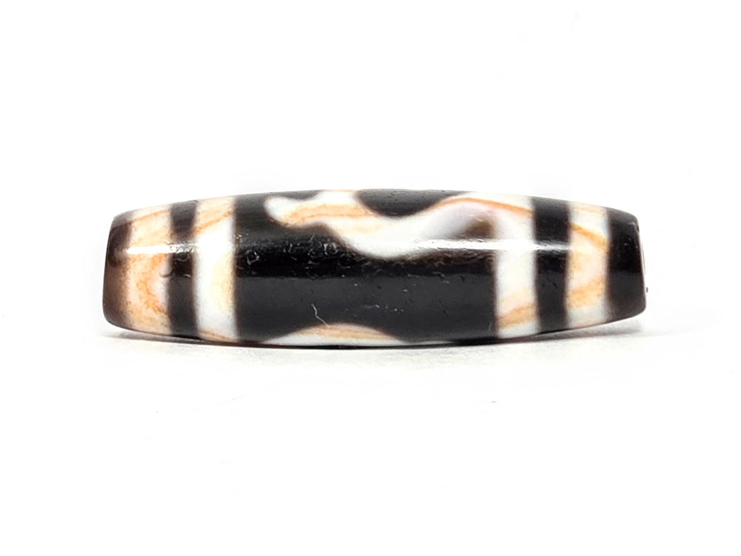 Antique Tibetan Green Tara Dzi bead — Side B reverse showing natural wave and stripe pattern on black agate with visible amber striations — unretouched photo — Ancient Dzi Shop