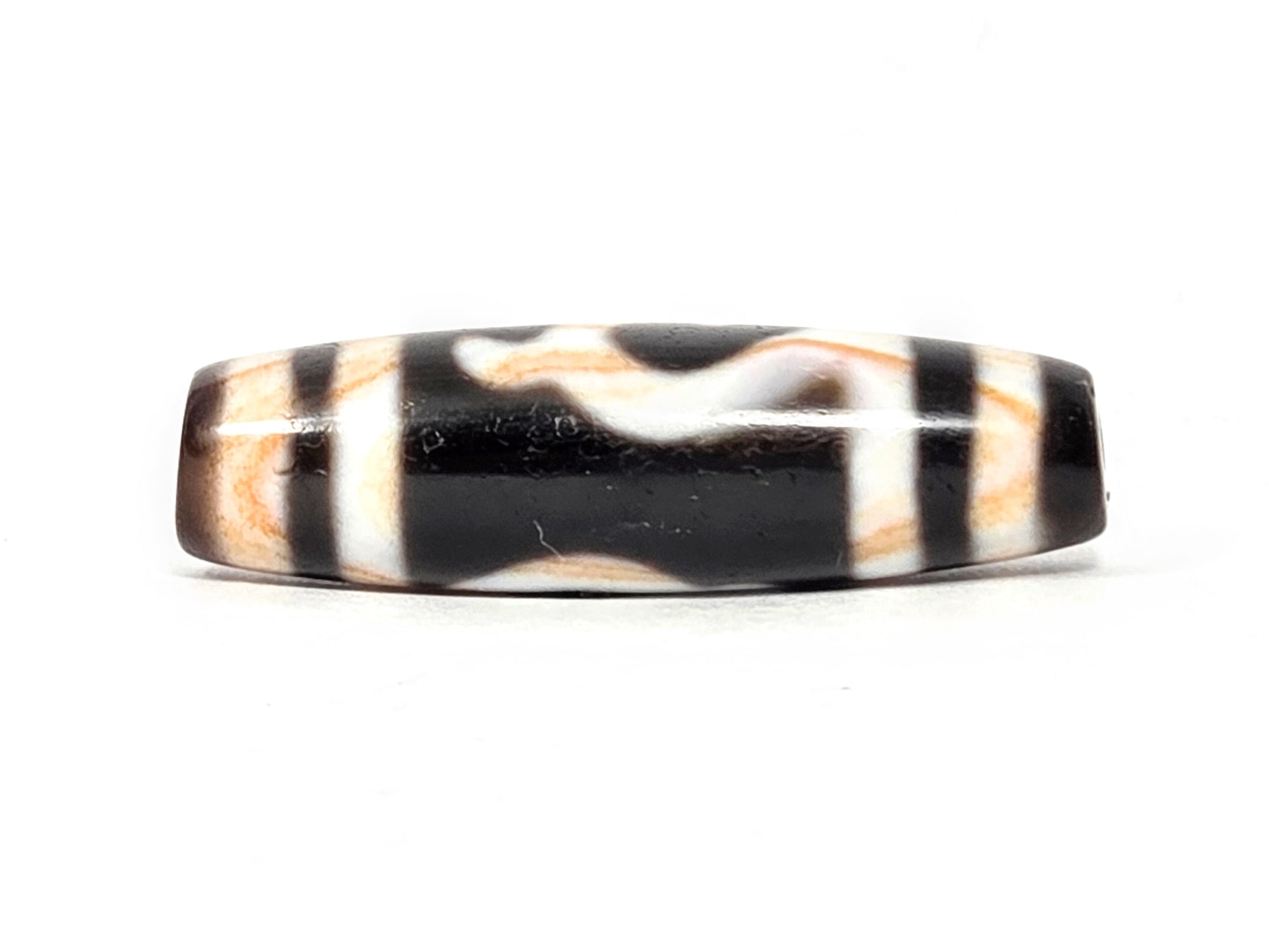 Antique Tibetan Green Tara Dzi bead — Side B reverse showing natural wave and stripe pattern on black agate with visible amber striations — unretouched photo — Ancient Dzi Shop