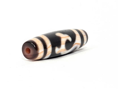 Antique Tibetan Green Tara Dzi bead — second drill hole end showing natural agate cap with warm amber patina and authentic surface — unretouched photo — Ancient Dzi Shop