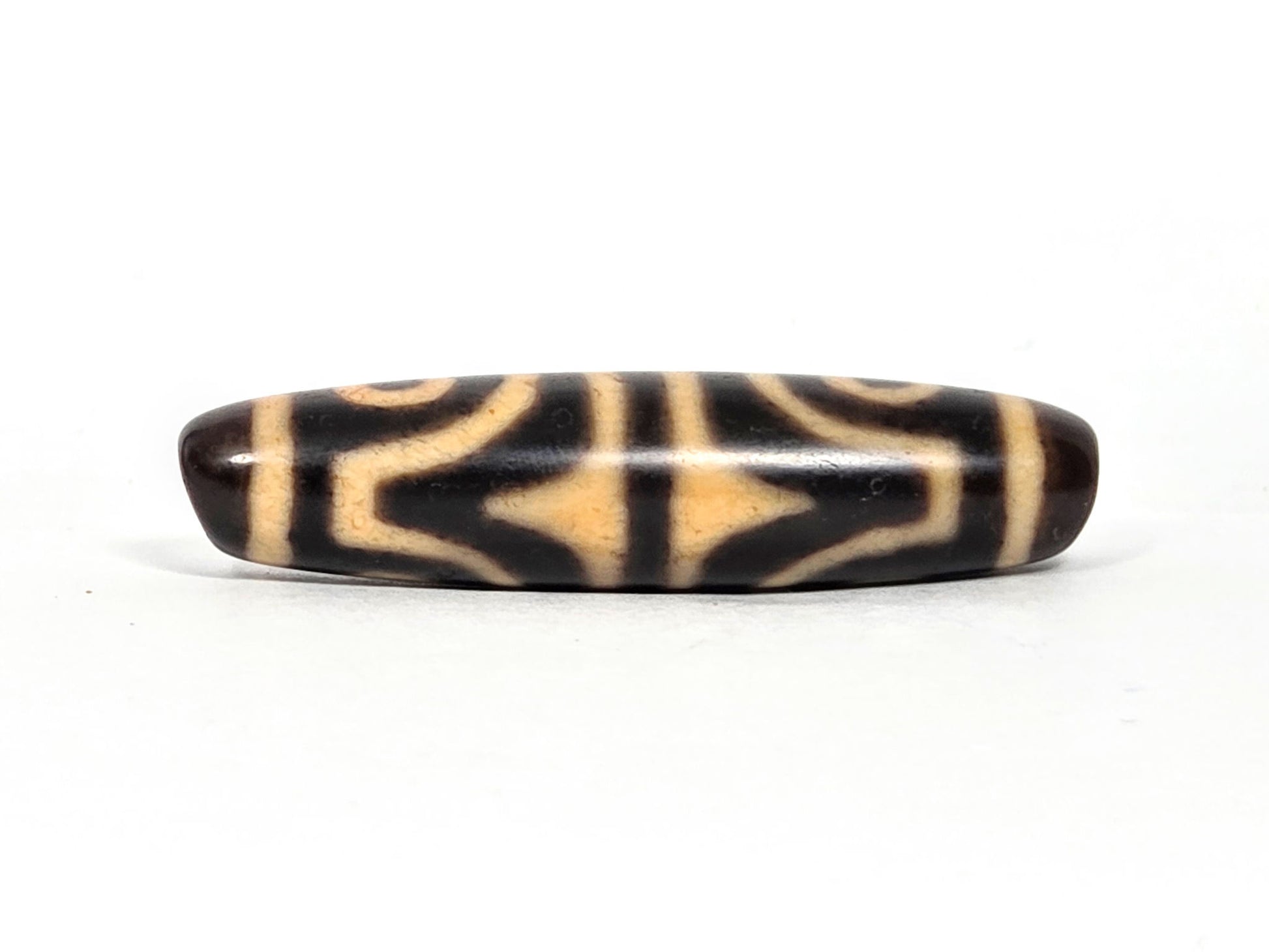 At-071026-4ETT antique four eye tiger tooth dzi very dark brown agate tiger tooth face 1 cream chevrons unretouched