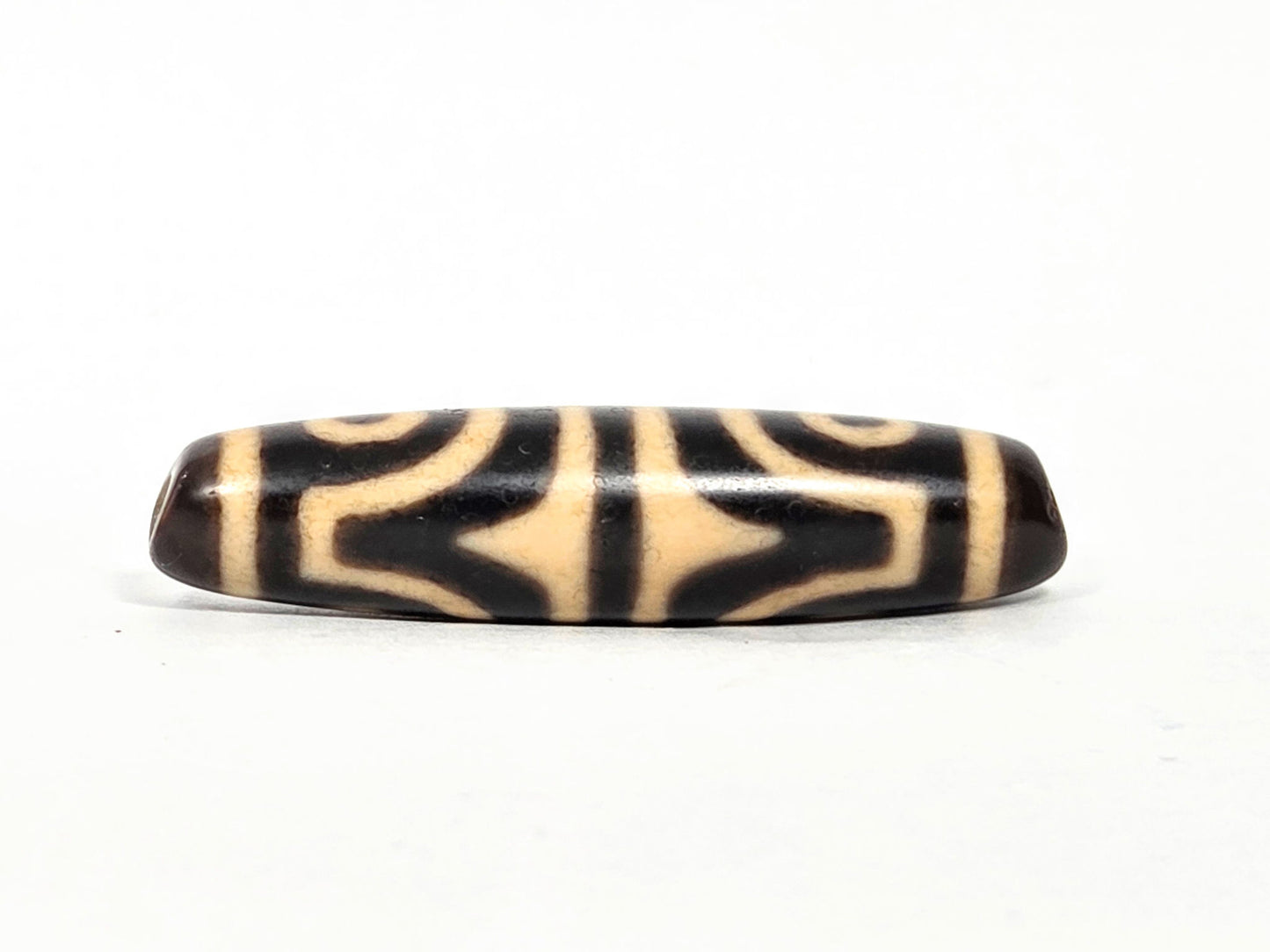 At-071026-4ETT antique four eye tiger tooth dzi very dark brown agate tiger tooth face 2 bold cream forms unretouched