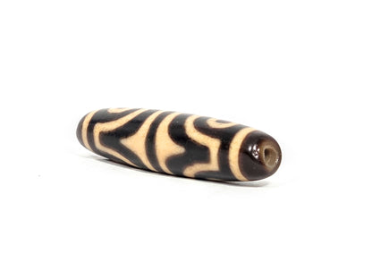 At-071026-4ETT antique four eye tiger tooth dzi angled view drill end warm brown end cap age wear unretouched