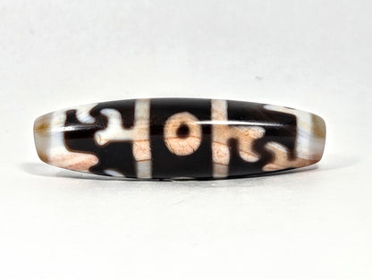 At-070626-GRRP3EBS rotated face 2, Guru Rinpoche three-eye dzi, pitch-black ground, cream-white & peach motif, unretouched