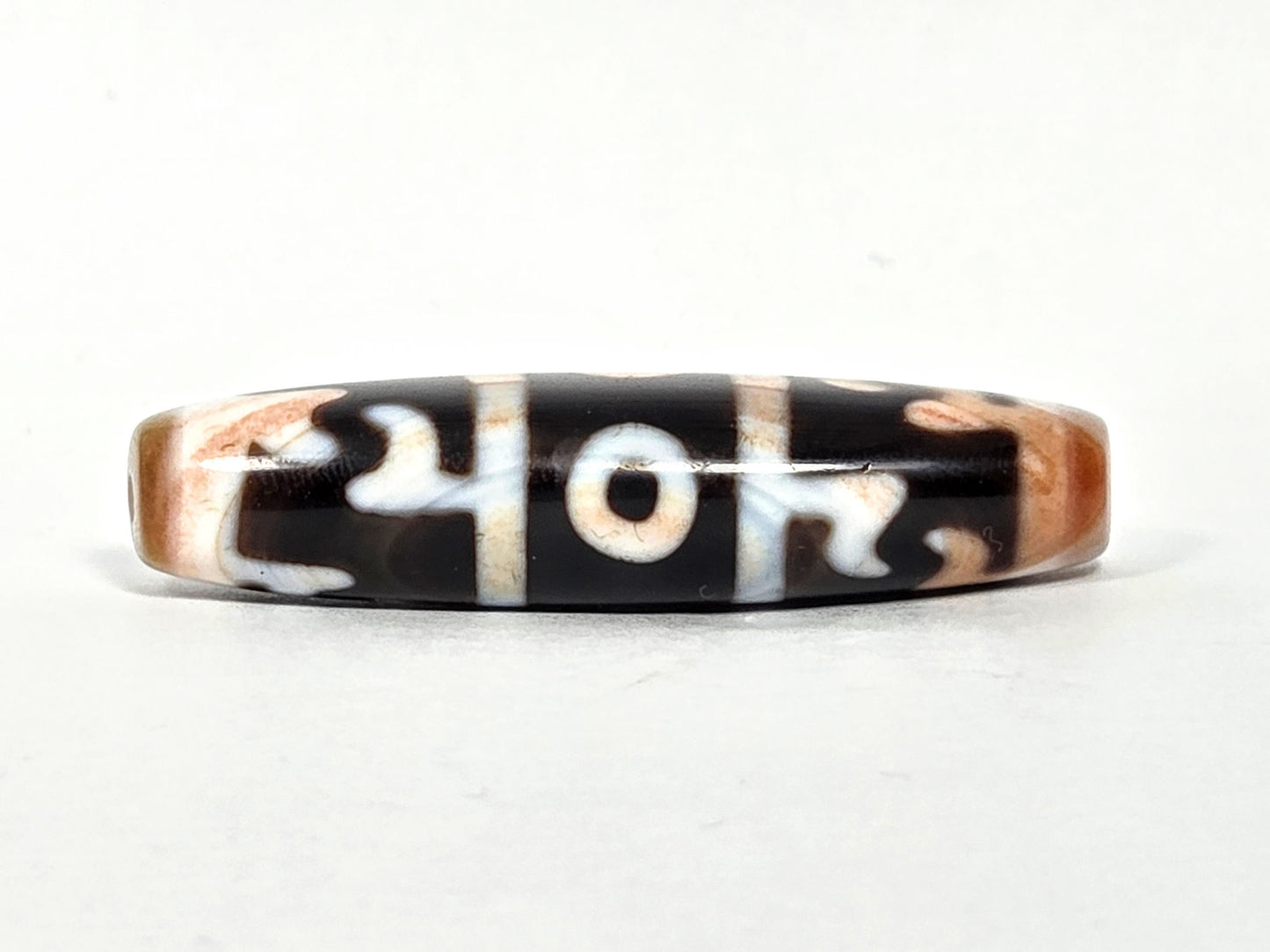 At-070626-GRRP3EBS rotated face 3, Guru Rinpoche three-eye dzi, bright cream-white motif lines, pitch-black ground, unretouched