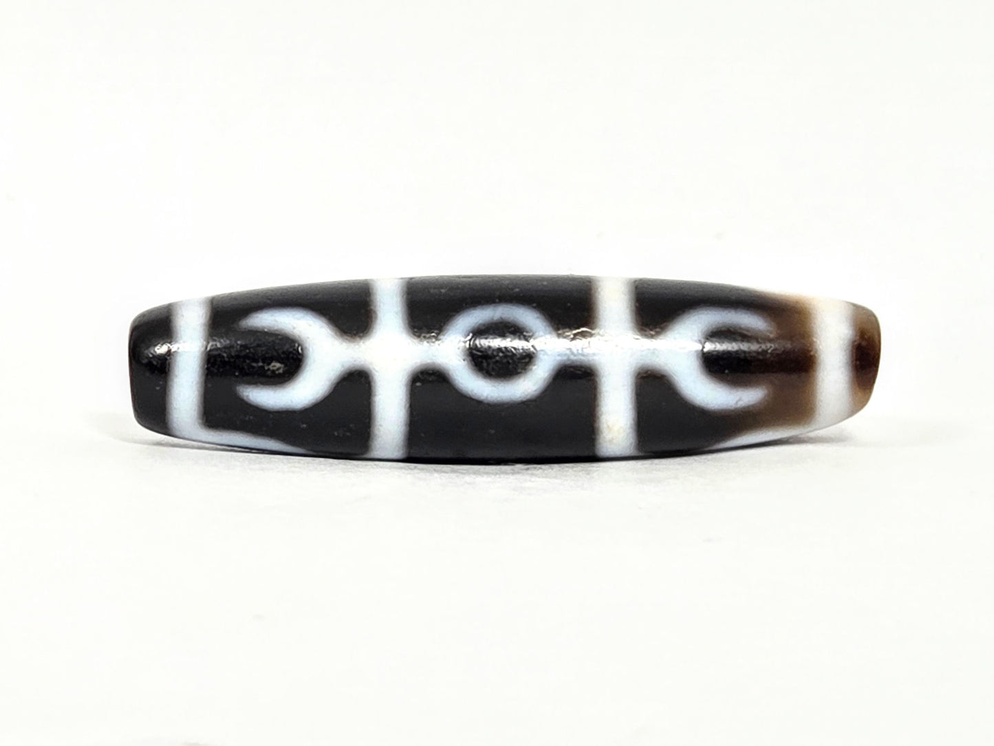 At-071426-GRS Guru Rinpoche Scepter face A low angle — central ring, flanking crescents, white lines, unretouched. 