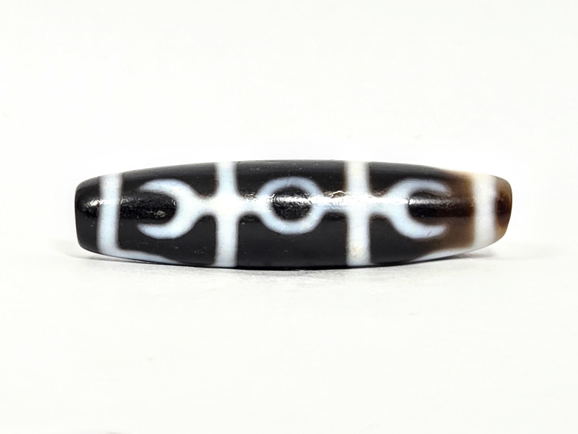 At-071426-GRS Guru Rinpoche Scepter face A low angle — central ring, flanking crescents, white lines, unretouched. 