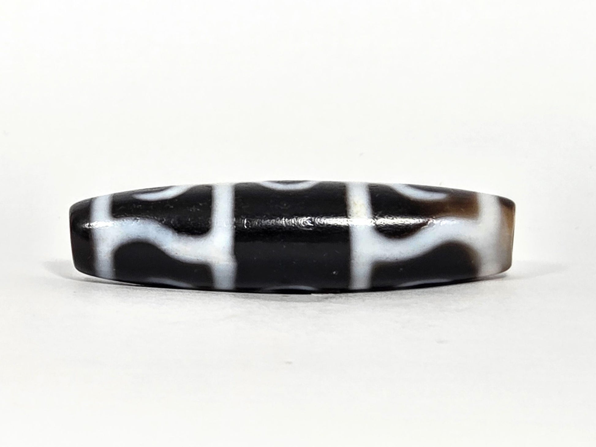 At-071426-GRS Guru Rinpoche Scepter face B low angle — arch-wave pattern, warm brown end cap, unretouched. 