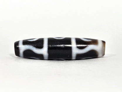 At-071426-GRS Guru Rinpoche Scepter face B low angle — arch-wave pattern, warm brown end cap, unretouched. 