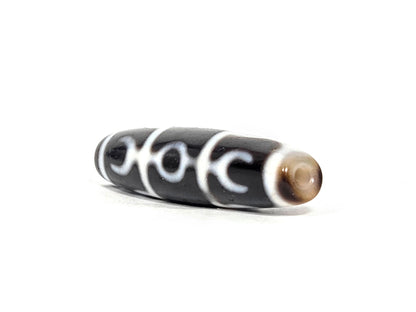 At-071426-GRS Guru Rinpoche Scepter end angle A — warm dark brown domed end cap, motif wrap visible, unretouched. 
