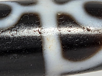 At-071426-GRS macro detail — cinnabar inclusions at motif-line boundary zones, bloodspot evidence, unretouched.