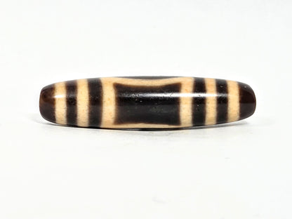 At-071326-HE opposite face C, angular trapezoidal oval reading, warm honey-cream patina on bar zones, unretouched