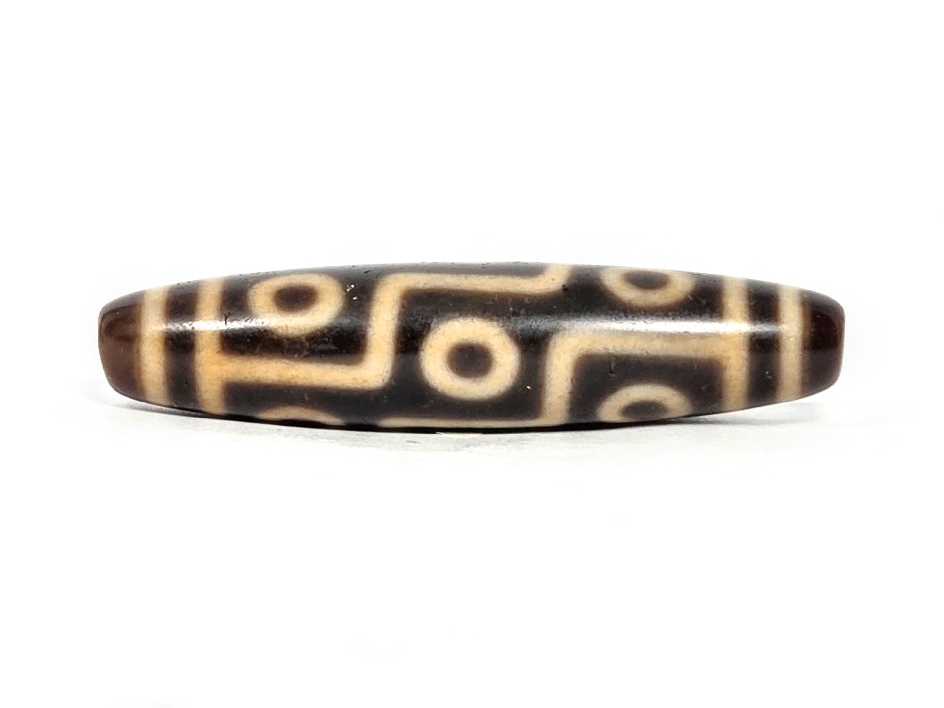 At-071326-9E face C, most pronounced honey-gold warmth in connector lines, warm dark brown agate, nine eye layout, unretouched