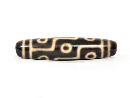 At-070826-9E antique nine eye dzi bead 59.8×13.7mm very dark brown agate front face cream motif unretouched