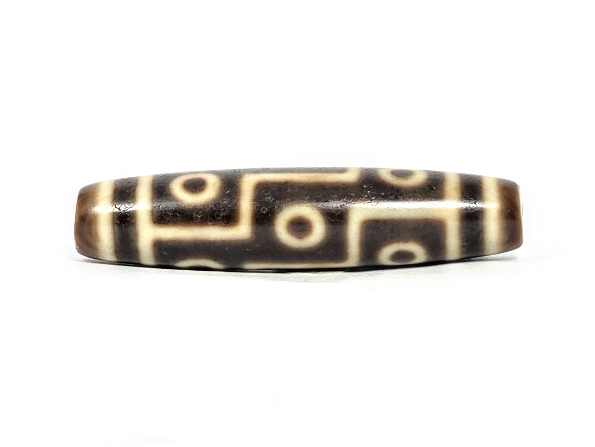 At-071126-9E6 face B, nine eye dzi, stepped S-curve connectors, warm cream-white motif lines, very dark brown agate, unretouched