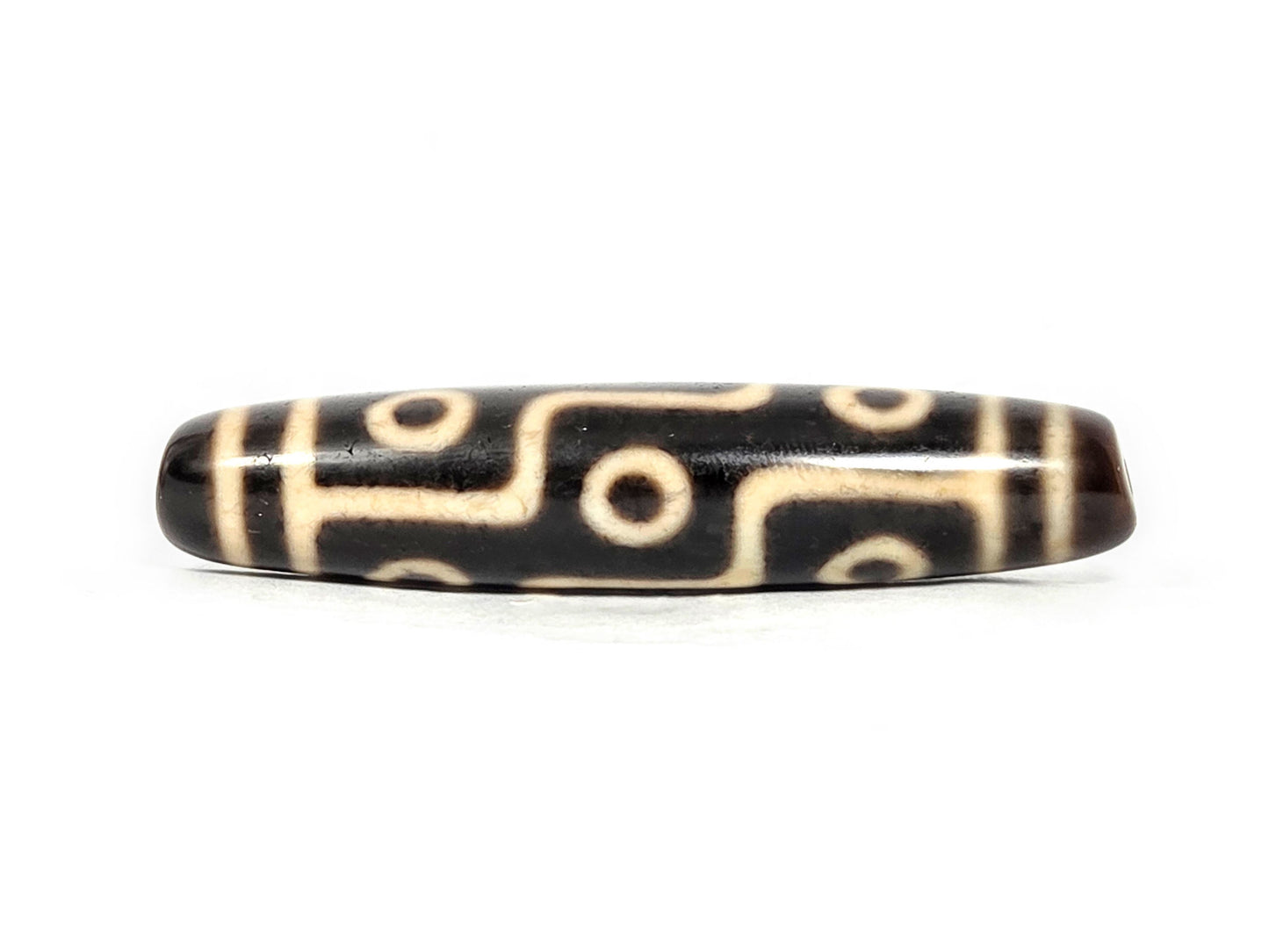 At-070826-9E antique nine eye dzi bead very dark brown agate third face showing cream craquelure zones unretouched