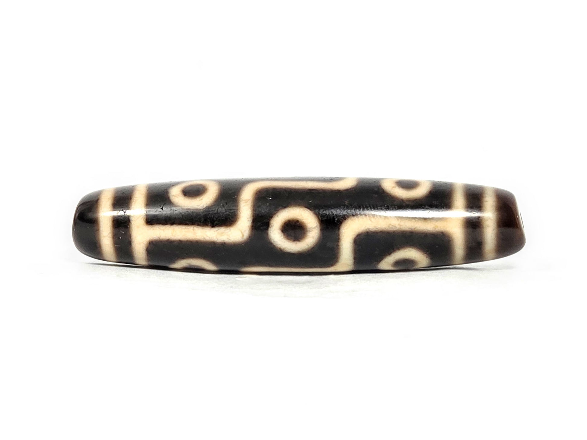 At-070826-9E antique nine eye dzi bead very dark brown agate third face showing cream craquelure zones unretouched
