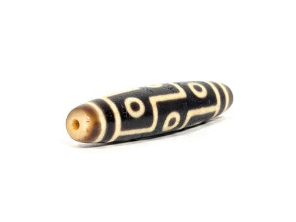 At-071126-9E7 drill-hole end, cool honey-cream cap, small centred hole, nine eye motif to end boundary, 300–500 yrs, unretouched