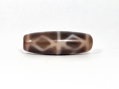 At-080926-6EDS2 antique Six Eye Diamond Spear dzi bead 33.0×11.5mm, Face B showing three diamond forms with slightly compressed profile, warm brown ground, unretouched